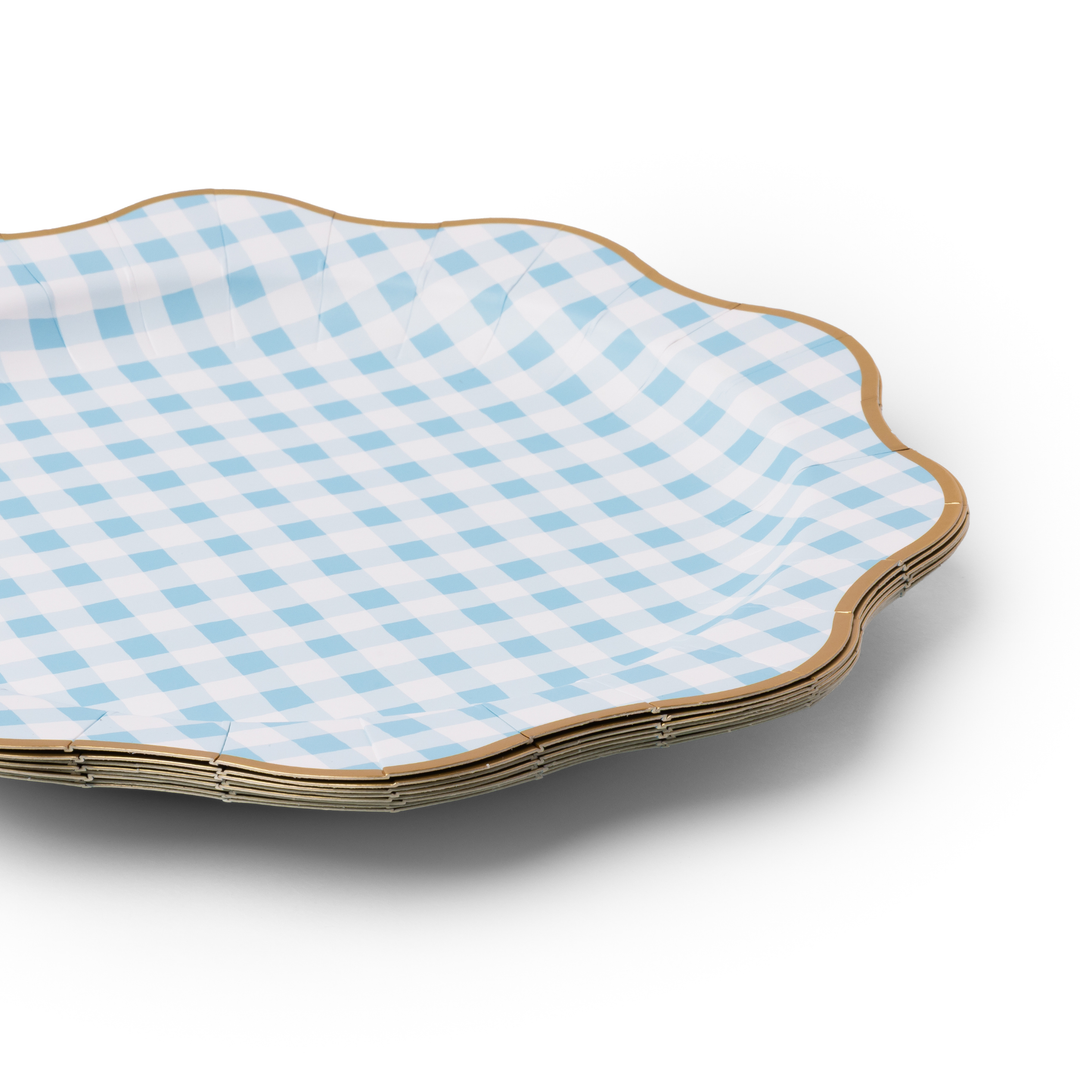 Scalloped-edge paper plate with blue checkered pattern on a white background