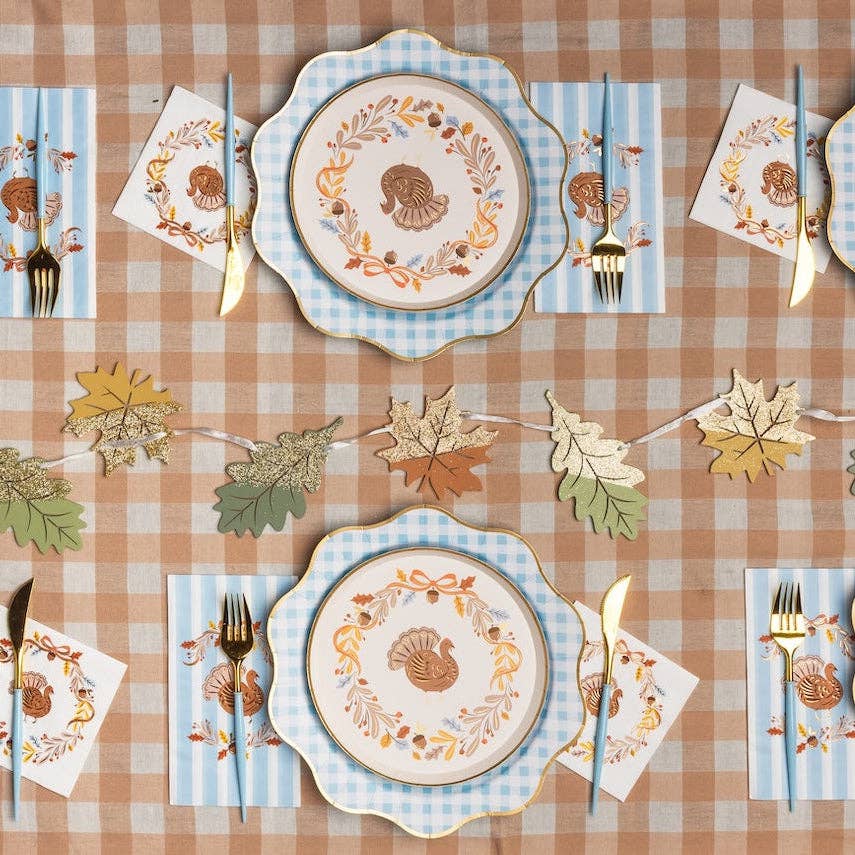 Thanksgiving table setting with turkey plates and autumn tableware