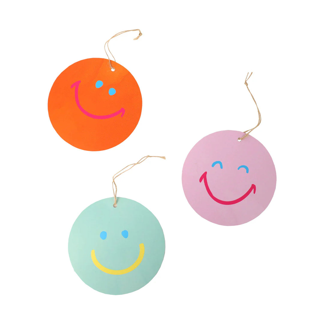 Happy Face gift tags pack of 8 in 4 designs, image shows 3 of the tags in colours bright orange, pink and mint green. 
